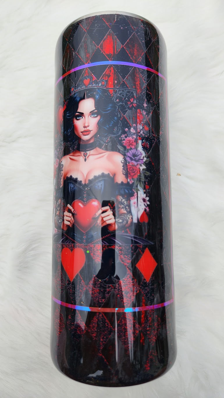"Glossy tumbler with a dark gothic design featuring a queen-like woman with black wavy hair, blue eyes, and a jeweled crown with a red heart. She wears a black corset and lace sleeves, holding a large red heart in her hands. The background includes roses, playing card suits, and a red-and-black diamond harlequin pattern."
